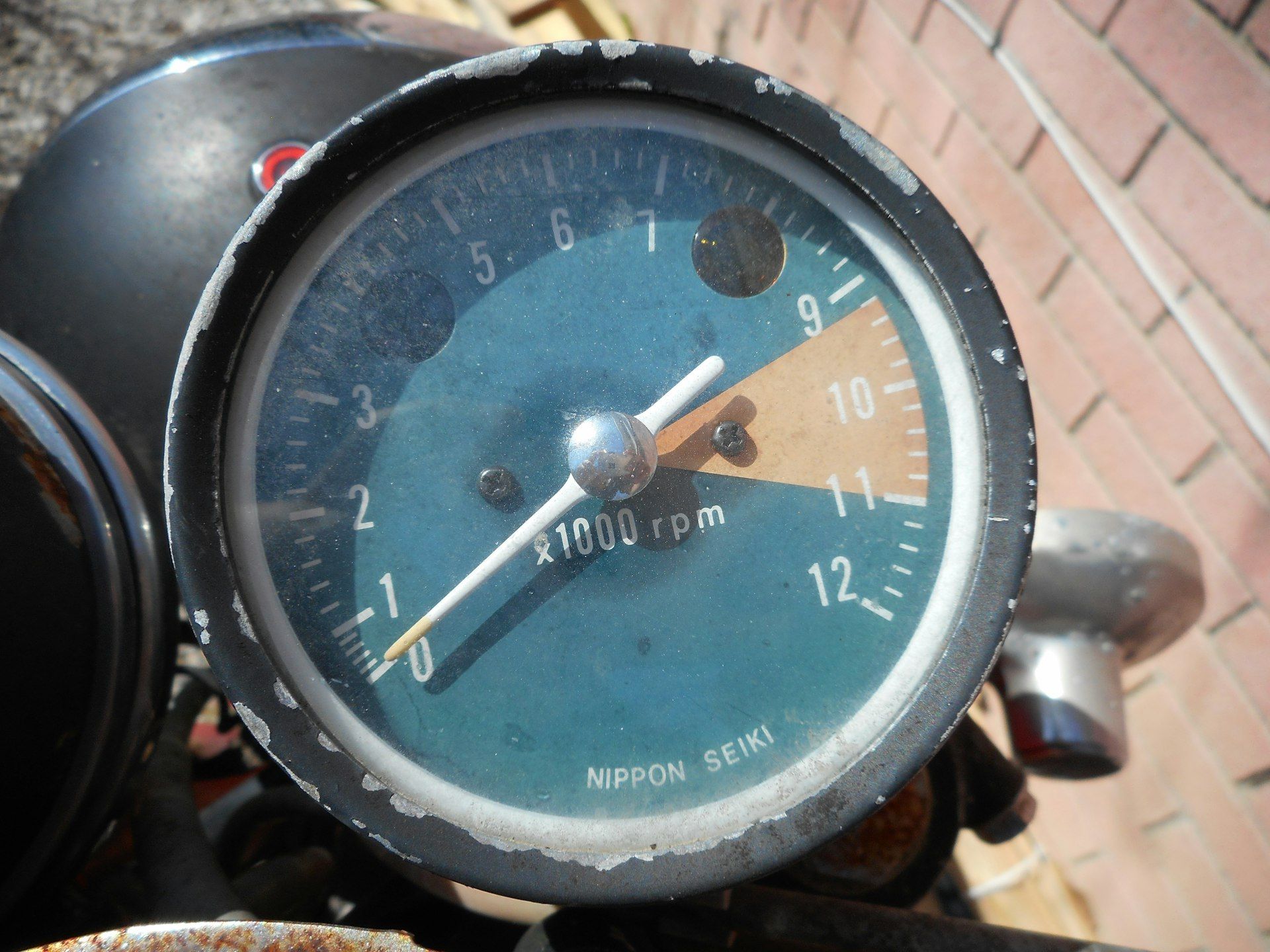 Close-up of a vintage motorcycle gauge